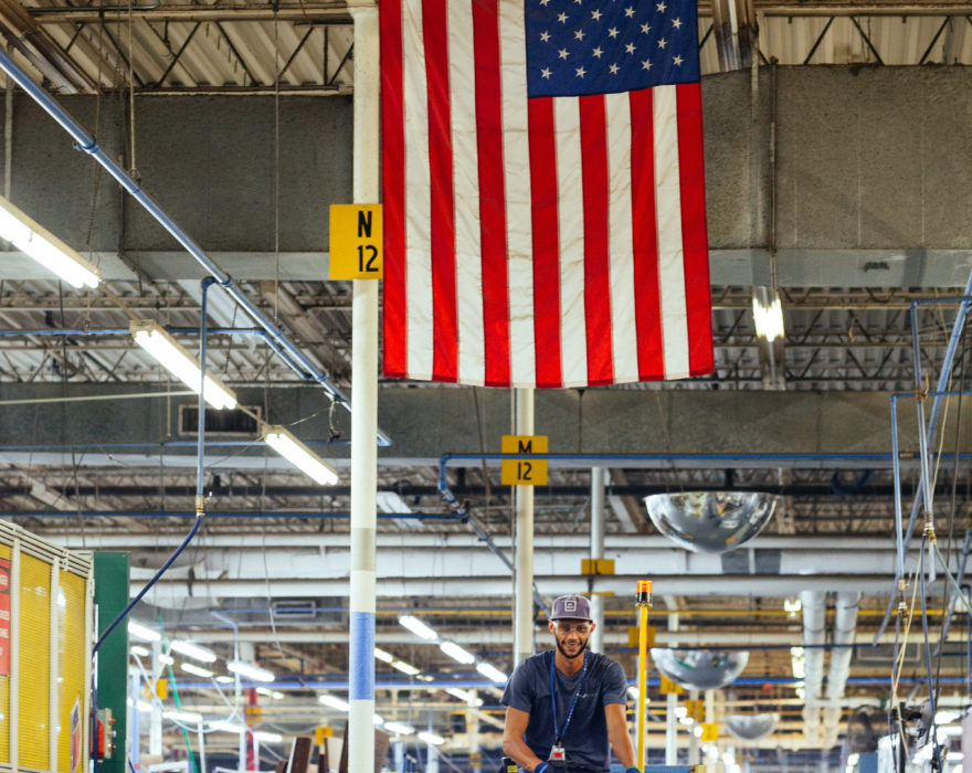 American flag hangs above a manufacturing worker in Chattanooga, Tennessee