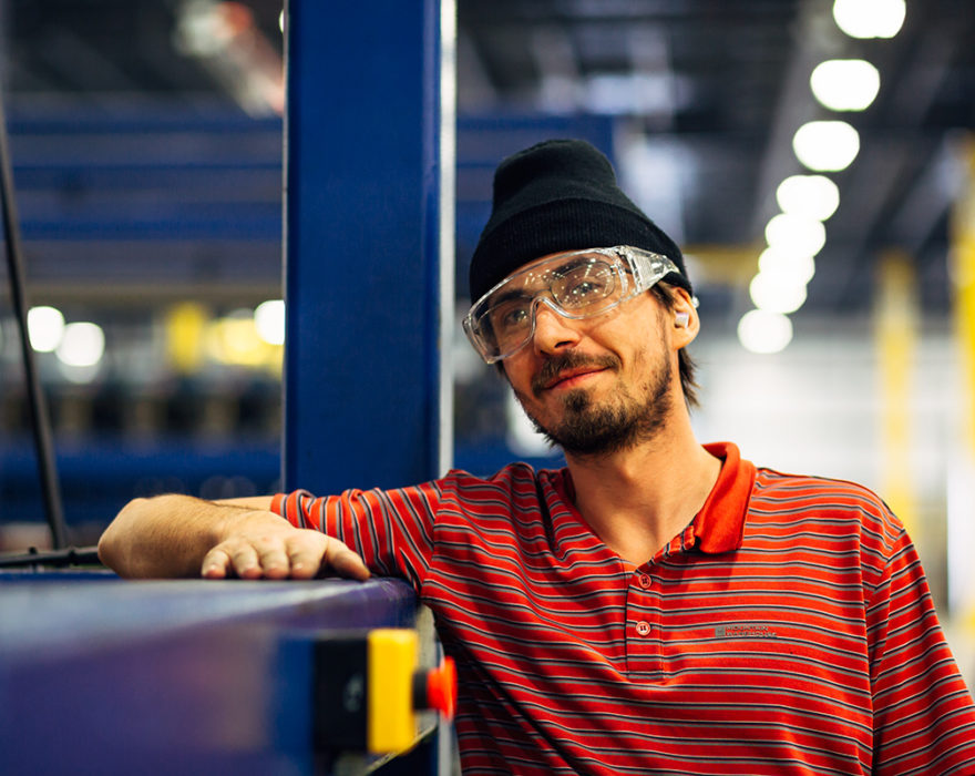 A warehouse employee wears protective eyewear next to machinery in Chattanooga, Tennessee