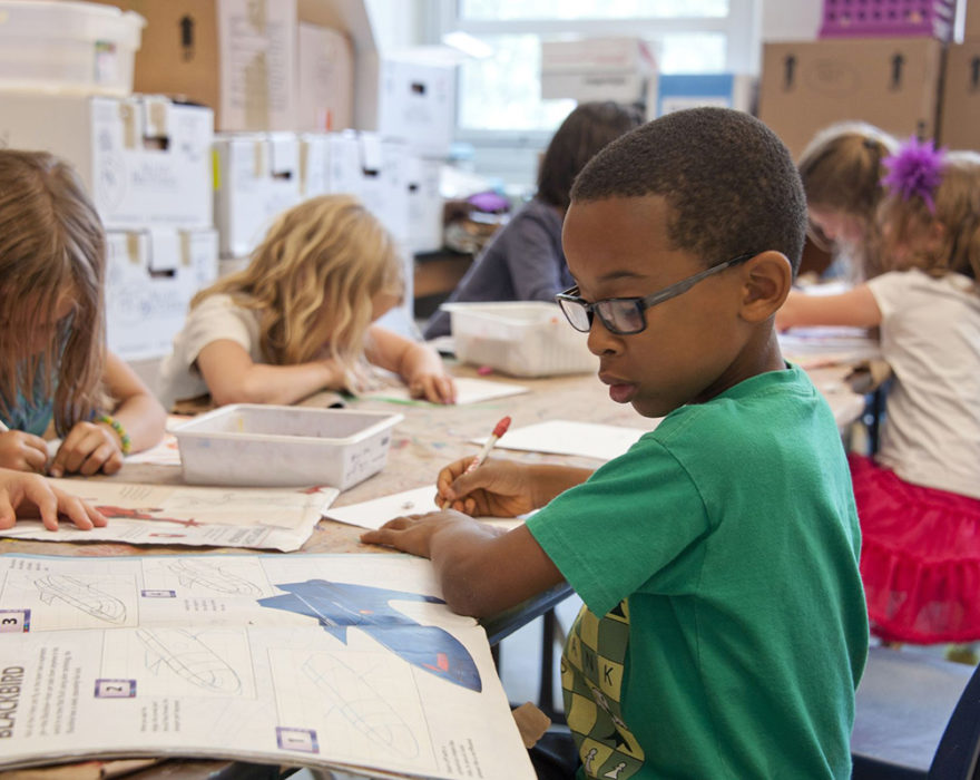 Children use workbooks in an elementary school classroom
