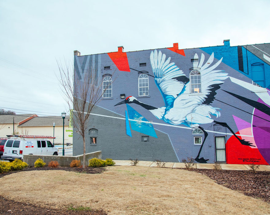 A colorful mural on the side of a building in downtown Chattanooga, TN depicts a large crane bird
