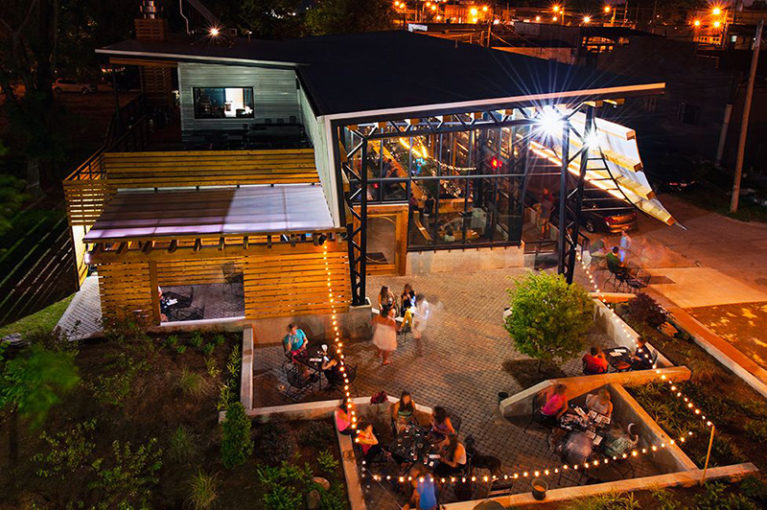 Groups of people dine at the outdoor patio of the Flying Squirrel Restaurant in Chattanooga, TN